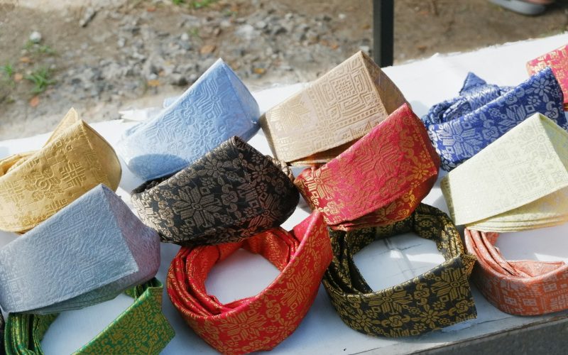 A table topped with lots of different colored ties